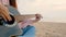 4K. close up of long hair woman playing acoustic guitar at the beach with gentle wind during sunset time, feeling relax