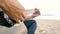 4K. close up of a man playing acoustic guitar at the beach during sunset time, feeling relax