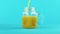 4K close-up shot of fruit orange multifruit juice cold beverage drink pooring into glass jar mug blue background in