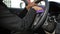 4K Close up shot hand of woman using purple micro fiber fabric to clean interior of suv car front panel