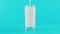 4K close-up shot of milk cold beverage drink pooring into low glass blue background in studio