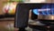 4K Close up view of part of a natural gas cooker or stove blue flame burning with blurred background