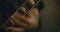 4K Closeup of fingers playing an electric bass guitar in a home studio.