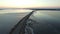 4K Compilation Video. Flight over road in frozen lake in early spring on sunset, aerial view