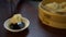 4K Dipping dumpling into soy sauce in restaurant. Traditional chinese food