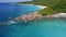 4K drone aerial side flight above azure crystal clear ocean water along picturesque coastline on tropical La Digue