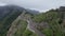 4k drone landscape of mountains and road in the middle.Woman walking on the road