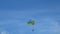 4K. excited tourists hanging on parasailing flying high in the sky, outdoor extreme sport summer activity. colorful parachute