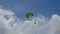 4K. excited tourists hanging on parasailing flying high in the sky, outdoor extreme sport summer activity. colorful parachute