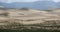 4k far away desert sand dunes under rolling cloud.