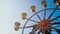 4K. ferris wheel rotation on blue sky background in sunny day