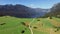 4K. Flight above amazing Bohinj Lake valley in the morning. Green hills and the road to Stara Fuzina village in Julian Alps.