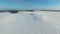 4K. Flight above snow fields in winter, aerial view (Snow desert)