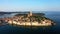 4K. Flight over beautiful Rovinj at sunrise. Morning aerial panoramic view of the old town of Rovinj.