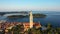 4K. Flight over beautiful Rovinj at sunrise. Morning aerial panoramic view of the old town of Rovinj and church of St. Euphemia.
