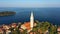 4K. Flight over beautiful Rovinj at sunrise. Morning aerial panoramic view of the old town of Rovinj and church of St. Euphemia