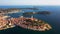 4K. Flight over beautiful Rovinj at sunset. Evening aerial panoramic view of the old town of Rovinj and islands, Istria, Croatia
