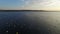 4K. Flight over fishing place with floats at sunset in the sea, aerial view.