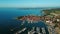 4K. Flight over old town Izola in Slovenia, aerial panoramic view with marina at sunset. Adriatic sea coast. Peninsula of Istria