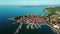 4K. Flight over old town Izola in Slovenia, aerial panoramic view with marina at sunset. Adriatic sea coast. Peninsula of Istria