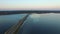 4K. Flight over road in the frozen lake in winter on sunset, aerial view