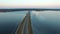 4K. Flight over road in the frozen water in winter on sunset, aerial view