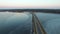 4K. Flight over road in the water in early spring on sunset, aerial.