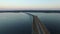 4K. Flight over road in the water in early spring on sunset, aerial.