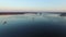 4K. Flight and takeoff over wild frozen lake in winter on sunset, aerial view