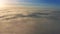 4K Flying forward above the clouds with beautiful golden clouds at sunrise