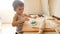 4k footage of adorable toddler boy playing with dough while making pie on kitchen