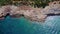 4K Footage Aerial Top View Of Stones In Turquoise Sea Water Waves Wash The Rocks