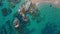 4K Footage Aerial Top View Of Stones In Turquoise Sea Water Waves Wash The Rocks, Sandy Coast