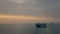 4K footage of cargo ship sailing across the sea in the dusk at sunset time. transportation and shipping concept