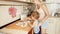 4k footage of cute toddler boy helping his mother rolling dough for pie on kitchen