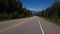 4K footage of driving on a road with the Canadian Rockies in the background