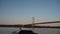 4k footage of Forth Road Bridge at sunrise with moon in view
