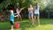 4k footage of happy children playing with mother and splashing and shooting water from toy guns at her