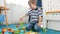 4k footage of little 4 years old boy building tower with colorful plastic bricks and blocks