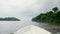 4k footage of motorboat sailing on big wide river in tropical jungle rainforest