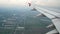 4K footage. traveling by air. aerial view through an airplane window at landing time. wing airplane moving to lower level