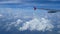 4K footage. traveling by air. aerial view through an airplane window. wing airplane and beautiful white clouds in blue sky