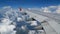 4K footage. traveling by air. aerial view through an airplane window. wing airplane and beautiful white clouds in blue sky