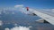 4K footage. traveling by air. aerial view through an airplane window. wing airplane and beautiful white clouds in blue sky