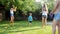 4k footage of two elder sister throwing toy airplane to their little toddler brother on grass at backyard