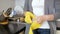 4k footage of young housewife wearing yellow latex gloves while doing housework