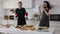4K, Funny energetic dance of lesbian couple in kitchen. Portrait of two cheerful beautiful Caucasian women dancing at home