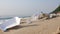 4K Garbage containers falling on sand, polluted beach.