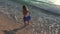 4K Girl Playing on Beach at Sunset, Happy Child Walking in Sea Waves on Seaside