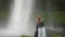 4K Girl standing in front of Seljalandsfoss Waterfall